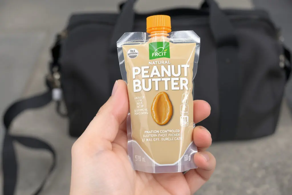 a single-serving squeeze pack of peanut butter highlighting the importance of strict portion control for this high-calorie food